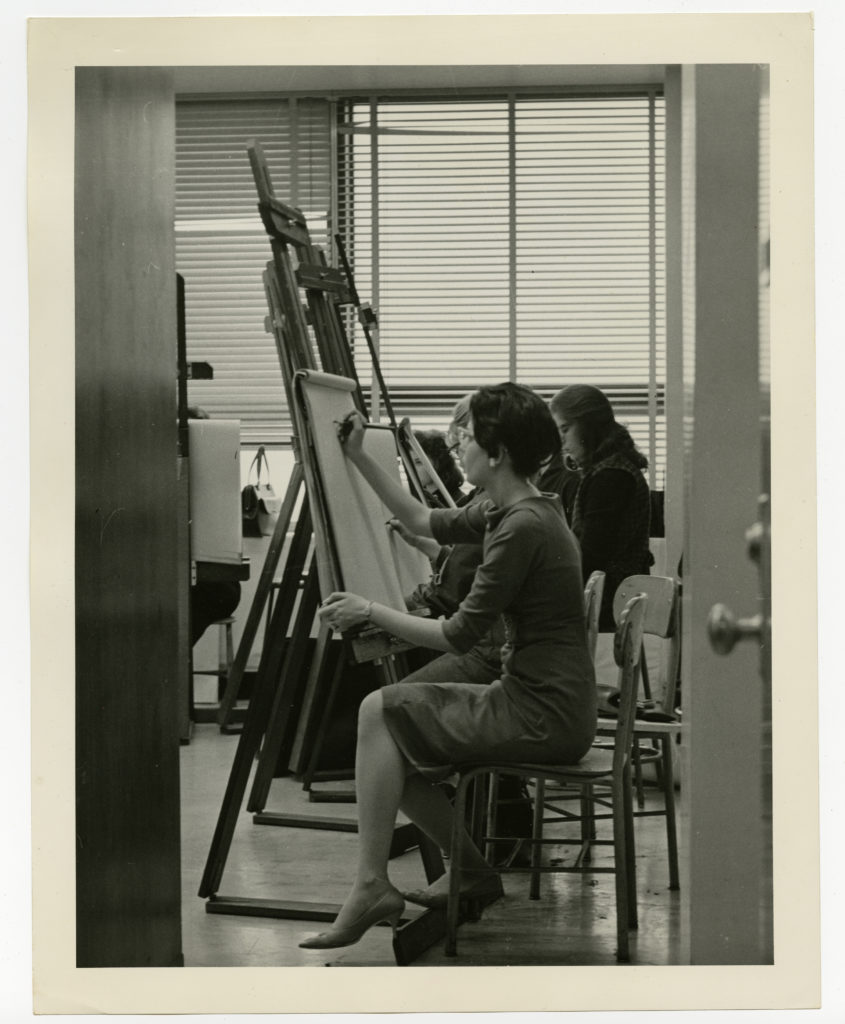 Woman painting at easel